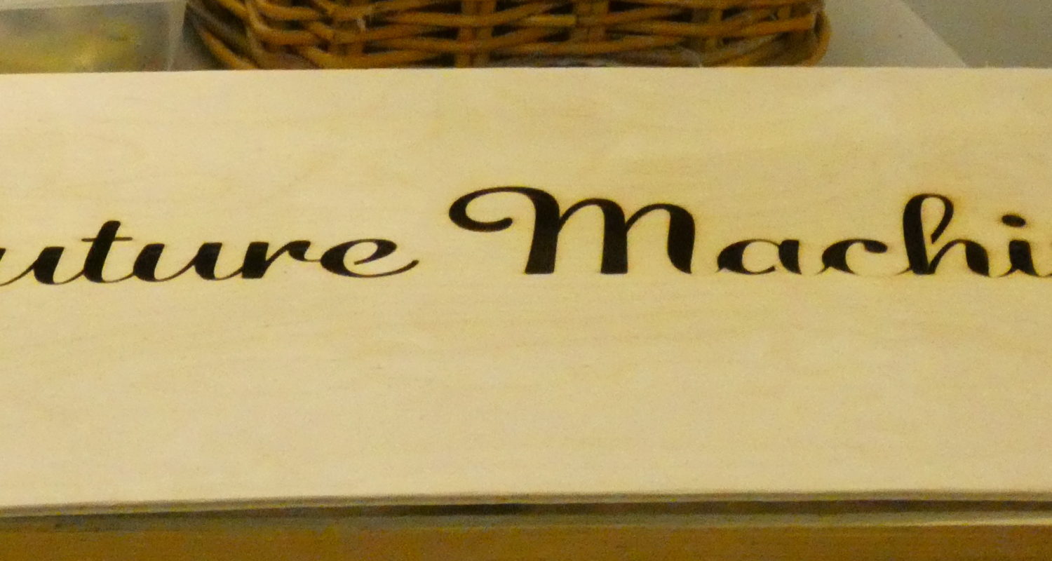 plywood sign with Future Machine logo