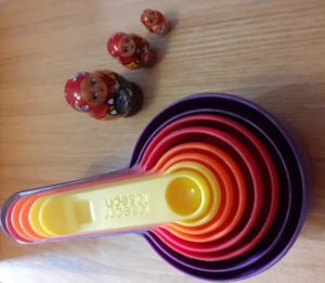 nested objects - rainbow coloured measuring cups and three Babushka dolls (large, small and baby) to inspire the Little Earth's workshop