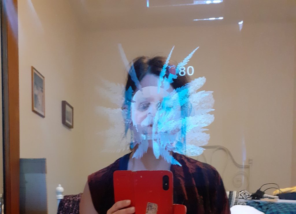 reflection of a face and top of the body in mirror with ghostly tentacles and another face appearing in front of the reflection