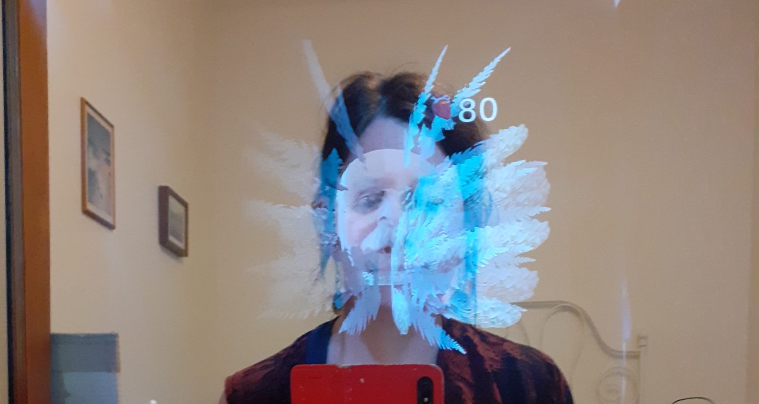 reflection of a face and top of the body in mirror with ghostly tentacles and another face appearing in front of the reflection