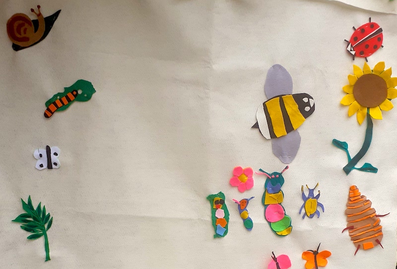 brightly coloured insects, flowers and leaves made from felt