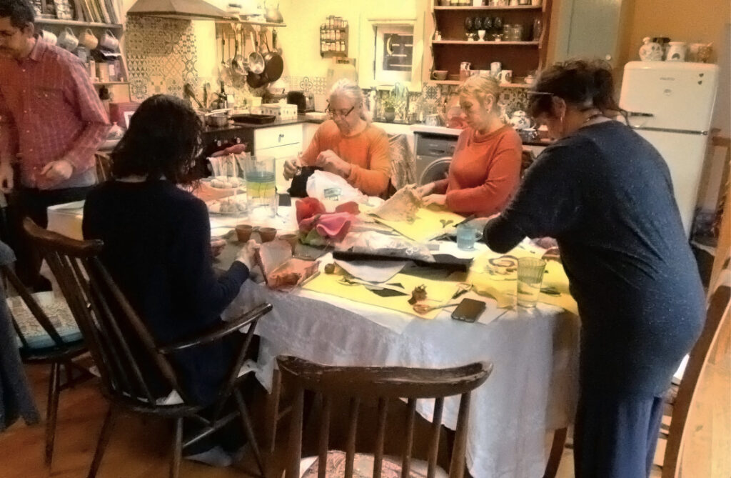 people standing and sitting around the table