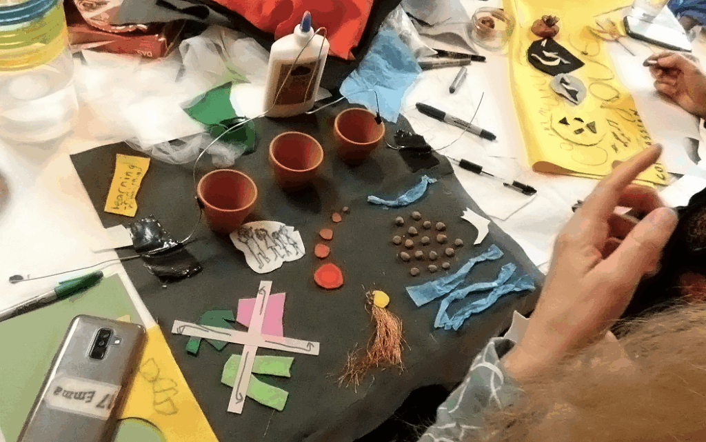 a felt artwork with small plant pots