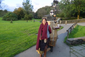 Rachel Jacobs with Future Machine on a path with grass on either side and trees in the background