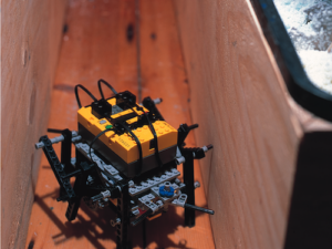 A yellow lego robot spider