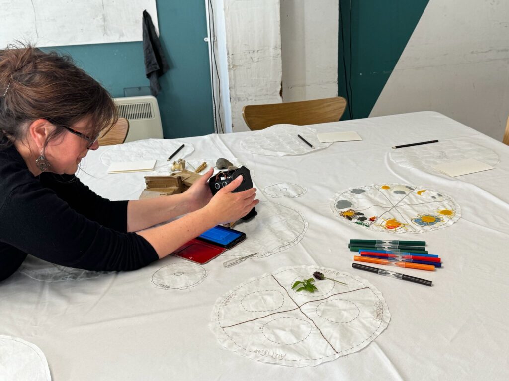 Rachel fixing a robot on the Kinship Table
